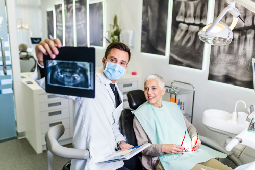 Handsome,And,Attractive,Male,Dentist,Looking,At,Dental,X-ray,Together