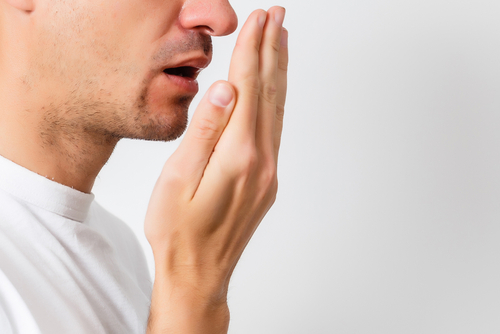 Bad,Breath.,Halitosis,Concept.,Young,Man,Checking,His,Breath,