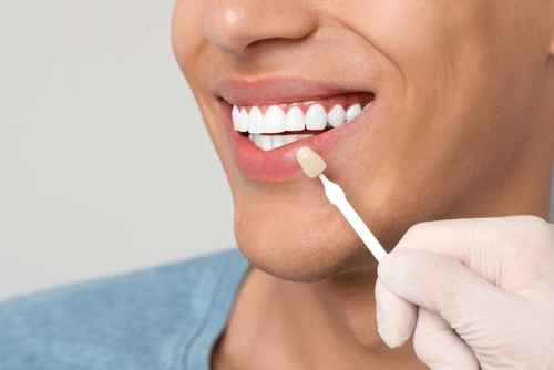 Doctor,Checking,Young,Man's,Teeth,Color,On,Gray,Background,,Closeup