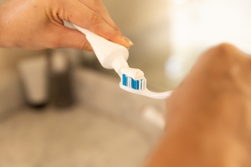Applying,Toothpaste,On,Toothbrush,,Preparing,For,Daily,Oral,Hygiene,Routine