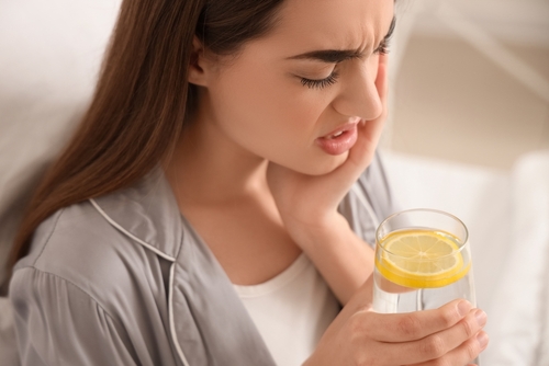 Young,Woman,In,Pajamas,With,Lemon,Water