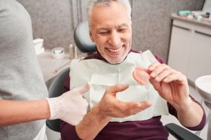 man looking at a set of teeth