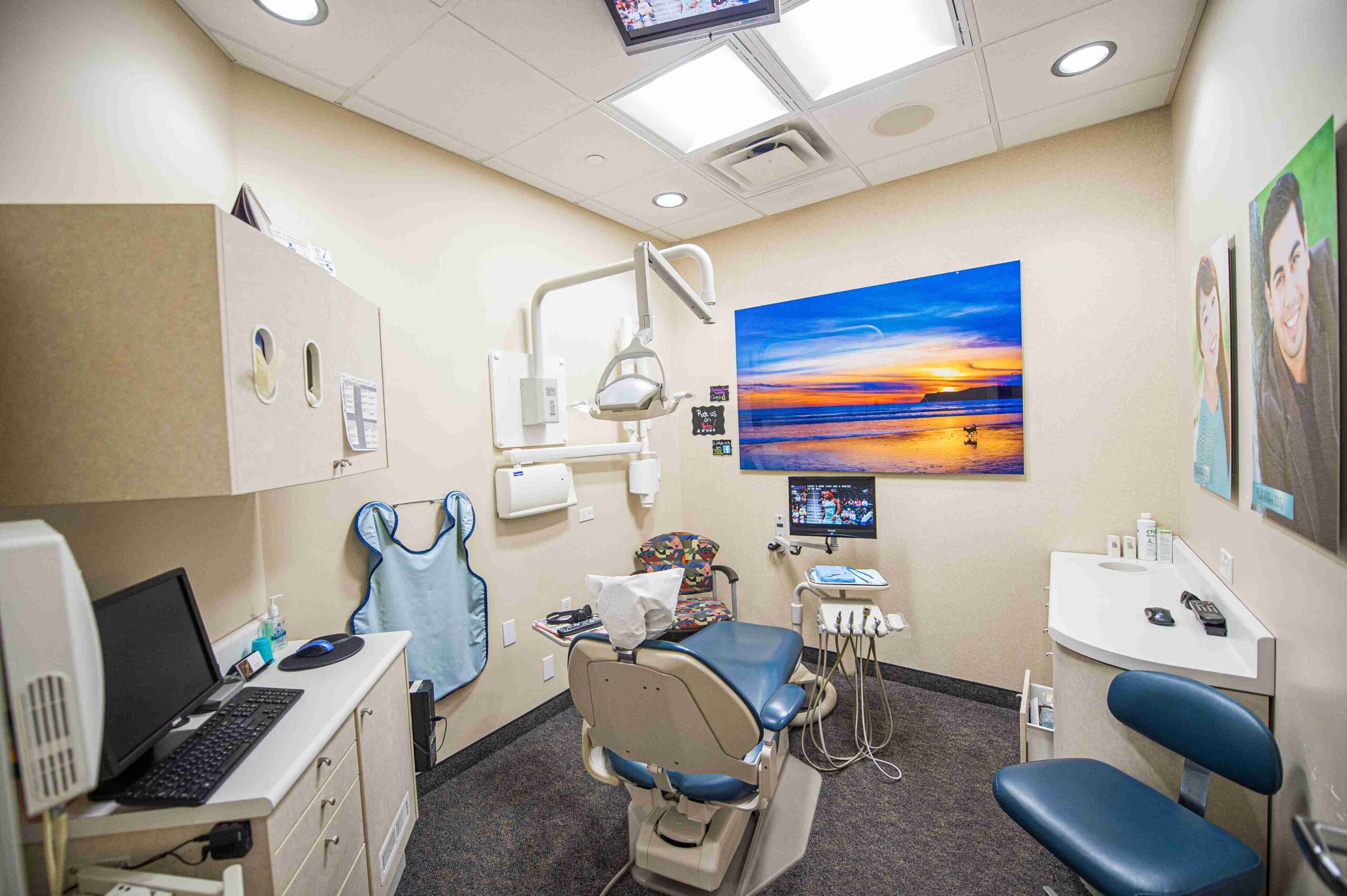 woman looking at her new smile in the mirror at the dentist